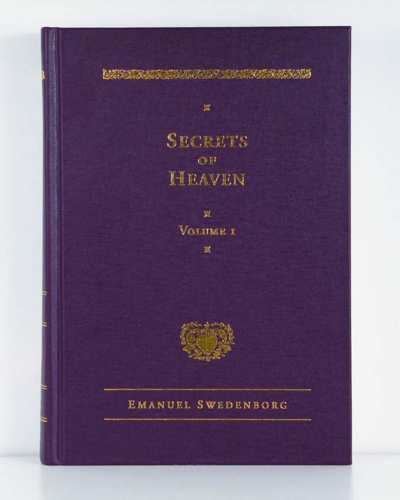 Purple cloth hardcover book with gold foil embossed type and ornaments
