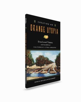 Paperback book upright, title on black background above image of irrigated citrus orchard