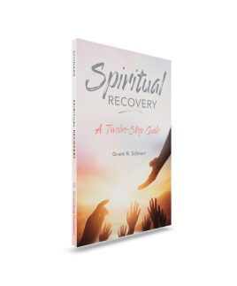 paperback book upright front cover with hands reaching towards light