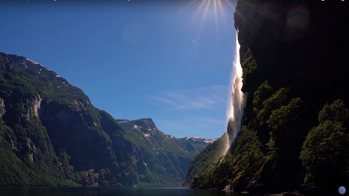 Photograph of the sun shining on a cliff face